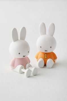 two small plastic rabbits sitting next to each other