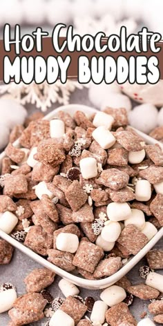 hot chocolate muddy buddies in a white bowl with marshmallows on the side