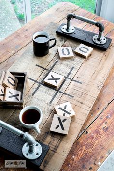 a wooden board with letters and numbers on it, next to a cup of coffee