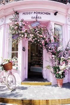 a pink building with flowers on the outside