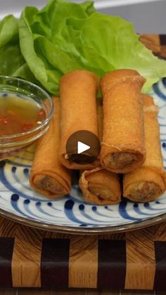 some food is on a plate with lettuce and dipping sauce in the bowl