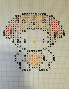 a cross - stitch pattern with an orange and black cat on it's face