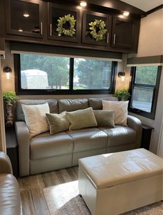 a couch and ottoman in front of a window