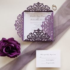 a purple and white wedding stationery with a rose