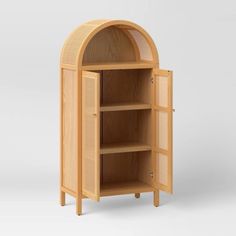 a wooden cabinet with an arched door and shelves on both sides, in front of a white background