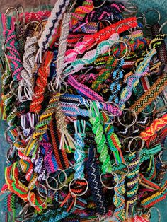 there are many different types of bracelets in this pile, and one is for sale