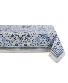 a blue and white tablecloth with floral designs on the border, set against a white background