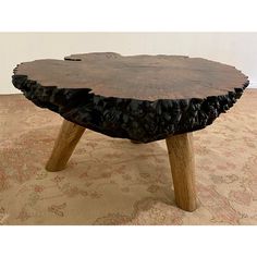 a table made out of tree stumps on top of carpet