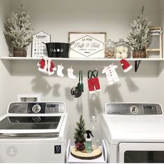 a washer and dryer in a small room with christmas decorations on the shelves