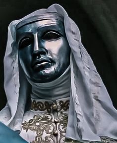 a close up of a statue of a person wearing a white veil and headdress