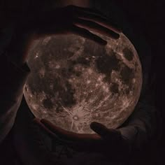 a person holding the moon in their hands