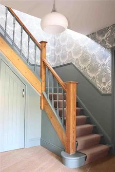 a stair case in a house with wallpaper on the walls