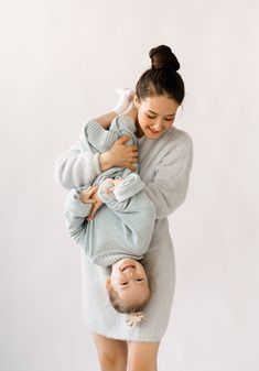 a woman holding a baby in her arms