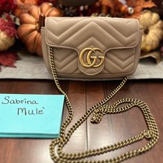 Authentic Gucci Marmont Mini Bag In Excellent Condition. No Marks Or Evidence Of Wear. Used Only A Few Times. Authenticity Verified And Certificate Available Gucci Marmont Mini Bag, Gucci Gold Wallet On Chain With Gold-tone Hardware, Gucci Beige Bags With Gold-tone Hardware, Gucci Bag With Gold-tone Hardware And Top Handle, Gucci Bag With Gold-tone Hardware In Signature Coated Canvas, Gucci Shoulder Bag With Gold-tone Hardware In Coated Canvas, Gucci Marmont, Gucci Bag, Mini Bag