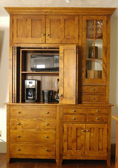 a wooden hutch with many drawers and cupboards