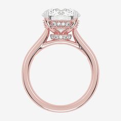 a rose gold engagement ring with an oval center stone