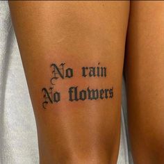 a woman with a tattoo on her leg that says no rain, no flowers in cursive writing