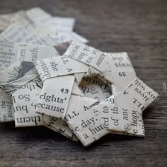 several pieces of paper that have been cut into small squares and placed on a wooden surface