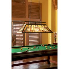 a pool table with a lamp hanging over it