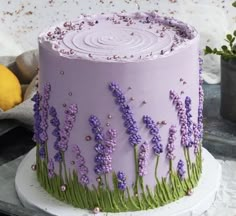 there is a cake decorated with lavender flowers