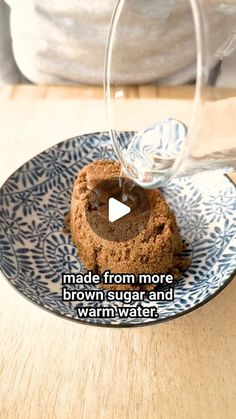 a chocolate cookie is being poured into a glass on a plate with the words made from more brown sugar and warm water