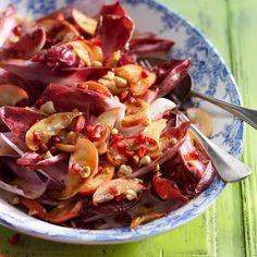 a bowl filled with red cabbage and nuts