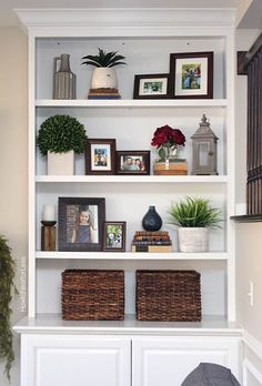 a white bookcase filled with lots of books