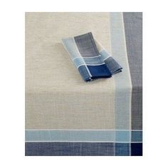 a blue and white striped table cloth on top of a wooden table next to a folded napkin