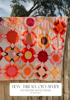 an orange and red quilt hanging on a fence with the words, few third old school patchwork block pattern