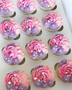 cupcakes decorated with pink and purple frosting