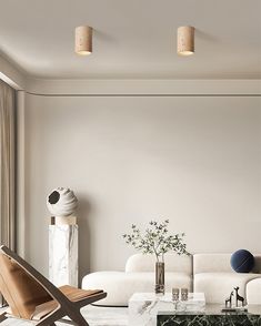 a living room with white couches and marble coffee table in front of a large window