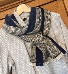 a blue and white scarf hanging on a wooden hanger