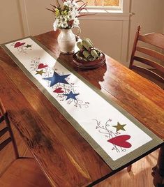 a wooden table topped with a vase filled with flowers