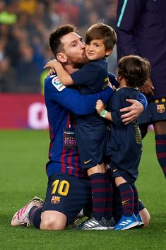 two soccer players are hugging each other on the field