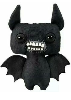 a black bat stuffed animal with big eyes