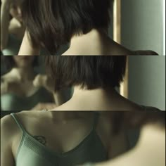 the woman is looking in the mirror with her hair pulled back and wearing a bra