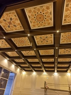 the ceiling in this room is decorated with intricate designs and lights, along with other decorative items