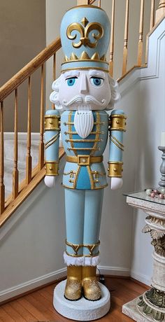 a statue of a nutcracker in blue and gold