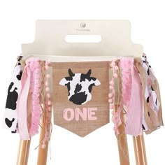 a wooden chair with a cow banner on it