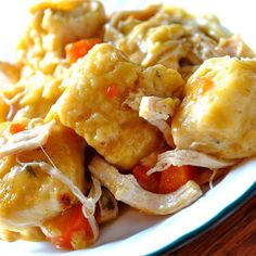 a white plate topped with food on top of a wooden table