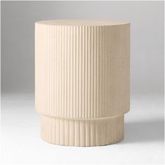 a white vase sitting on top of a table