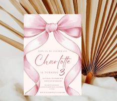 a pink ribbon and bow is on the front of this elegant birthday party invitation card