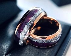 two wedding rings with purple stones and diamonds