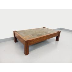 a wooden coffee table sitting on top of a white floor