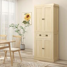 a dining room with a table and chairs next to a tall wooden cabinet in front of a window