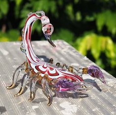 a glass crab sitting on top of a wooden table