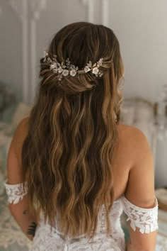 the back of a woman's head wearing a bridal hair comb with flowers on it