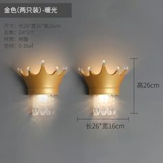 two gold crowns are on the wall next to each other, one is light up