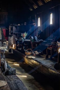 the sun shines brightly through two windows in an old fashioned room filled with furniture