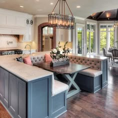 a large kitchen with an island in the middle and lots of seating on top of it